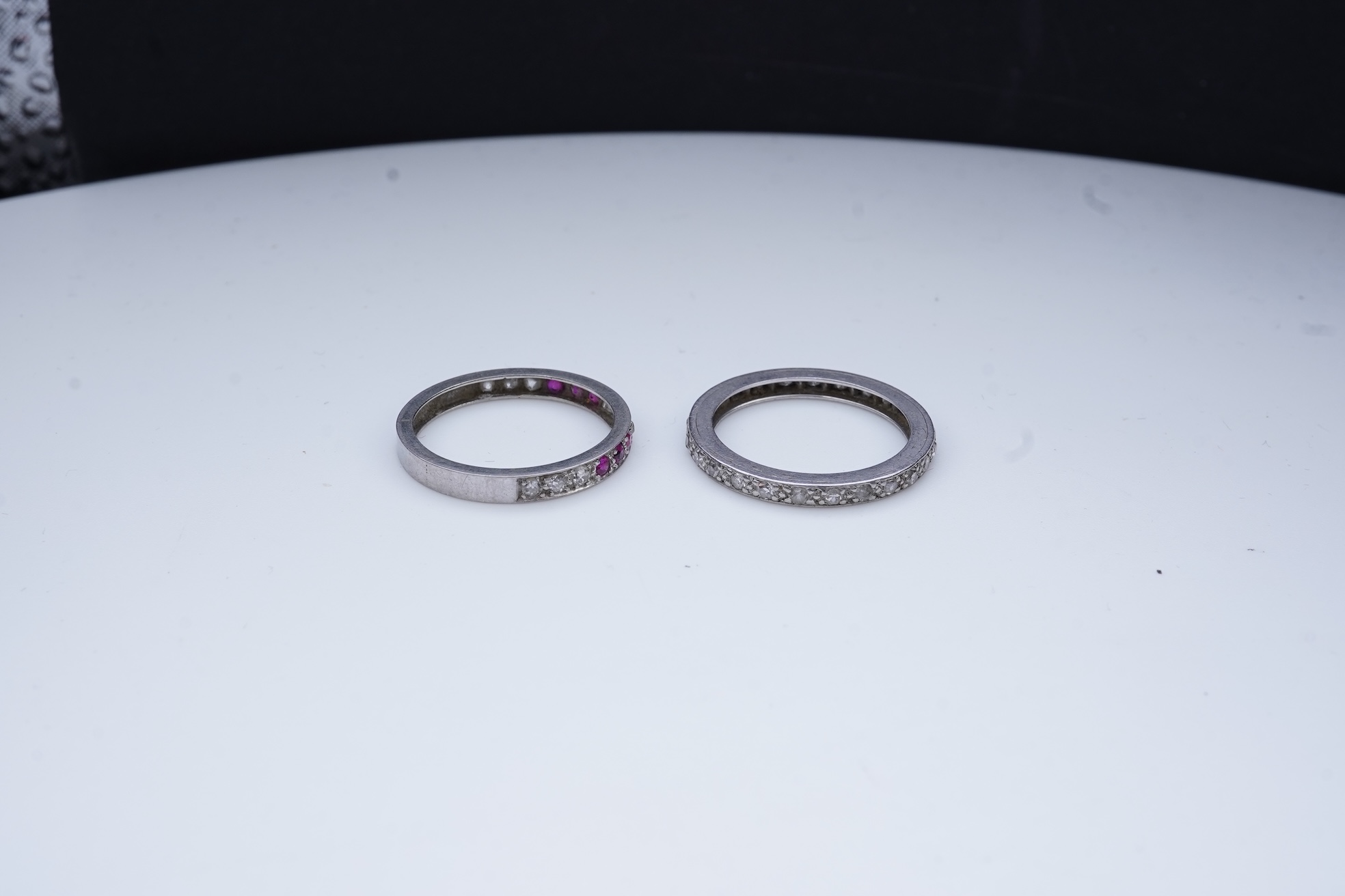 A diamond eternity ring and a ruby and diamond half eternity ring, mid 20th century